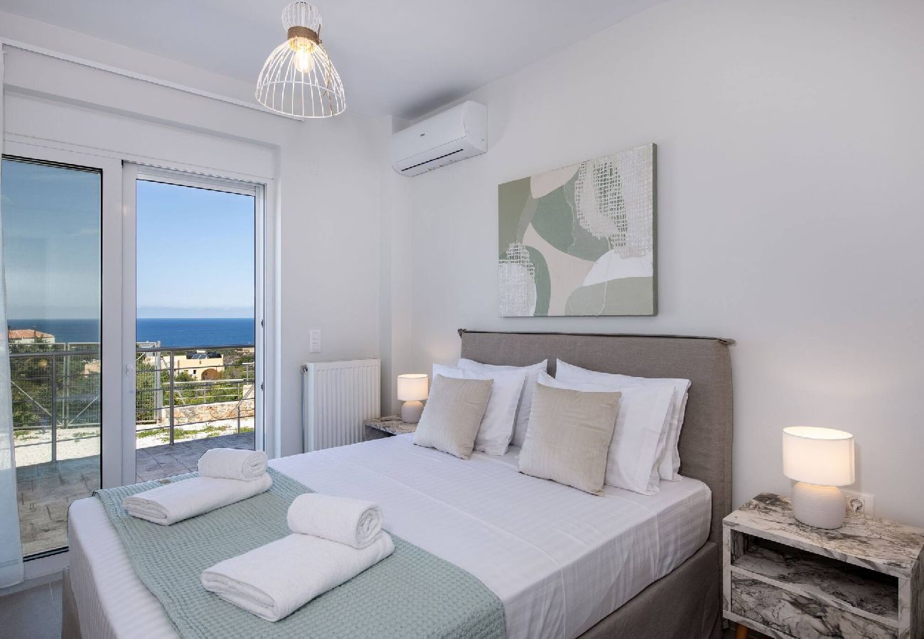 Master bedroom with balcony and sea view in Chania luxury villa