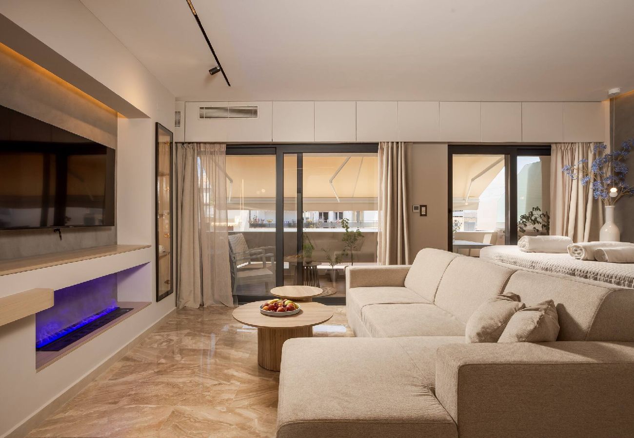 Modern living room with fireplace at Kira apartment in Chania city center