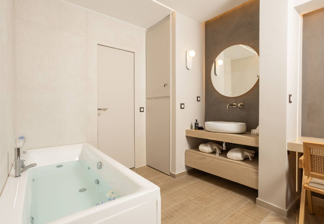 Luxury bathroom with tub and rainfall shower at Kira apartment Chania