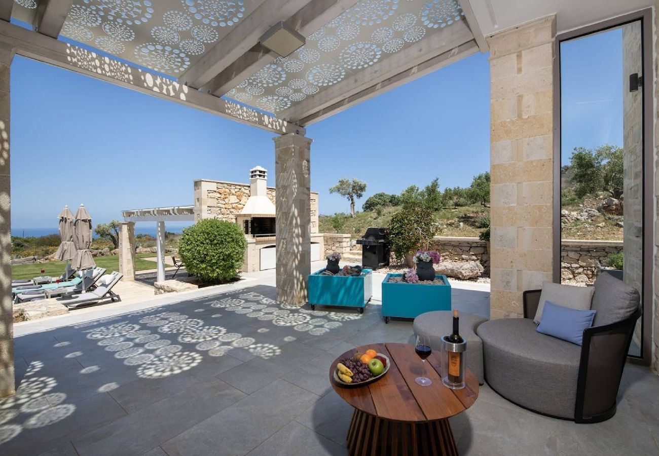 Outdoor seating and BBQ facilities at Aurora villa in Prines