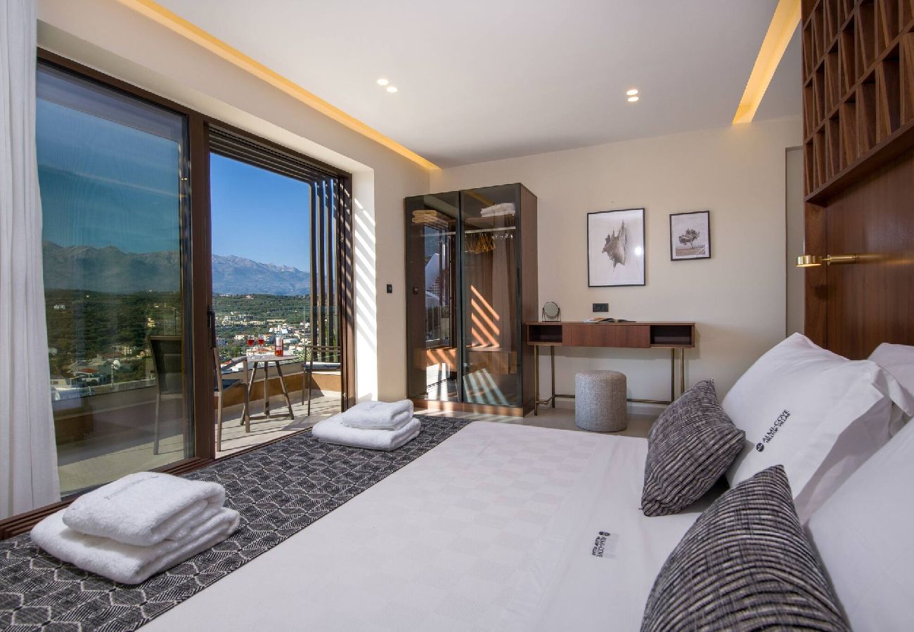 Master bedroom with balcony at Almi Cove Villa II Crete