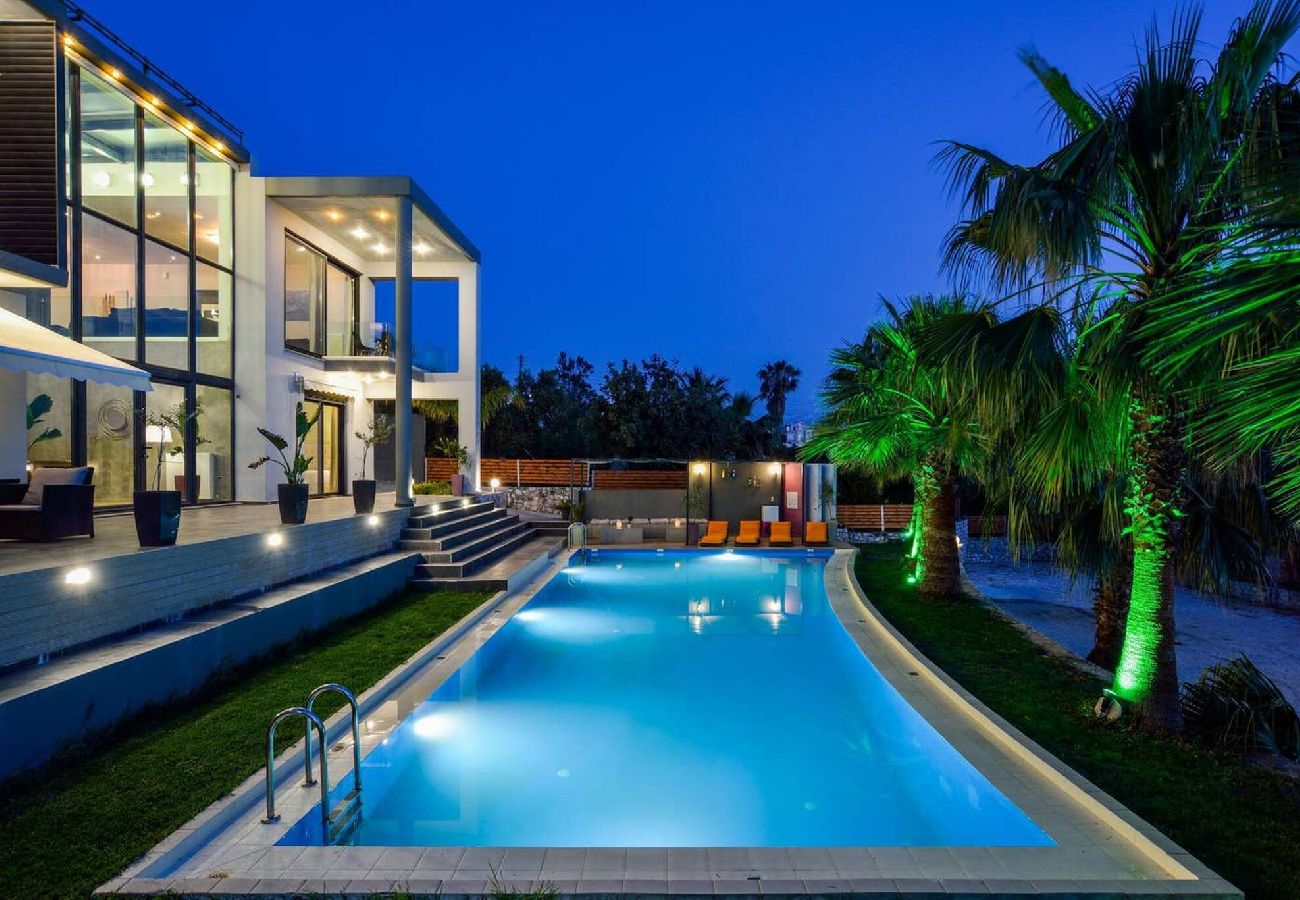 Night view of private pool at luxury villa Tersanas