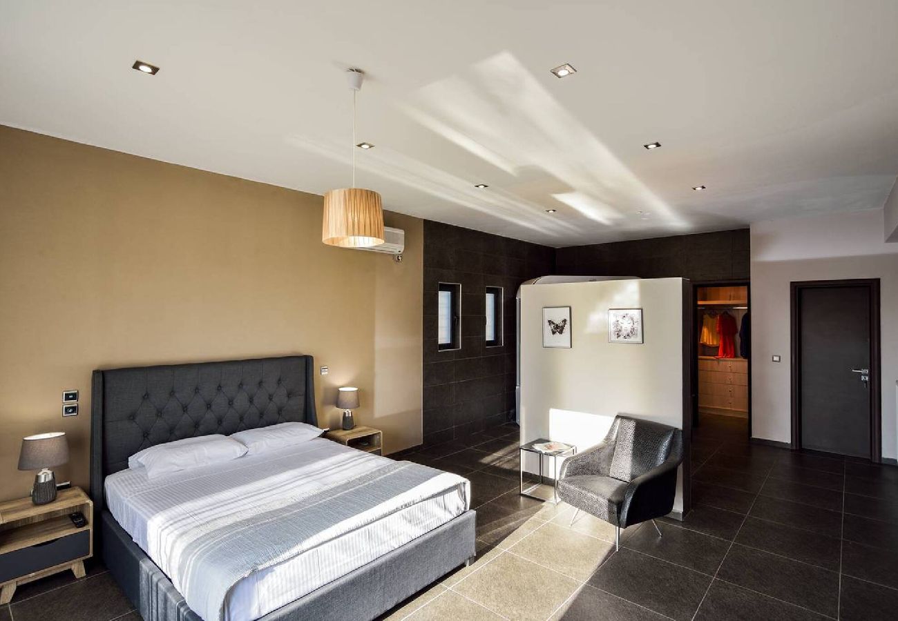 Master bedroom with balcony in Tersanas villa Crete