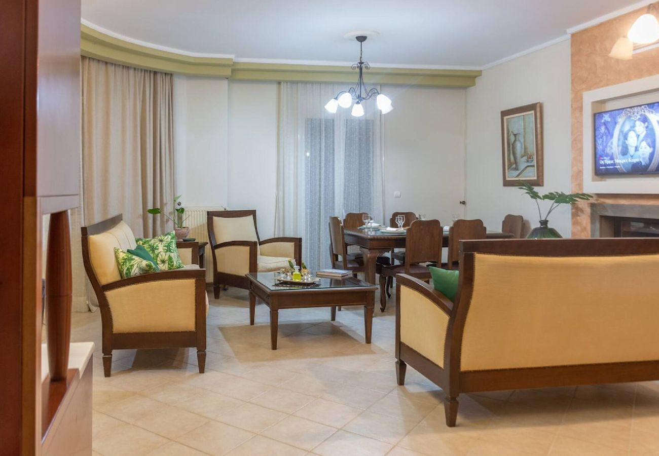Spacious living room with fireplace in Chania apartment
