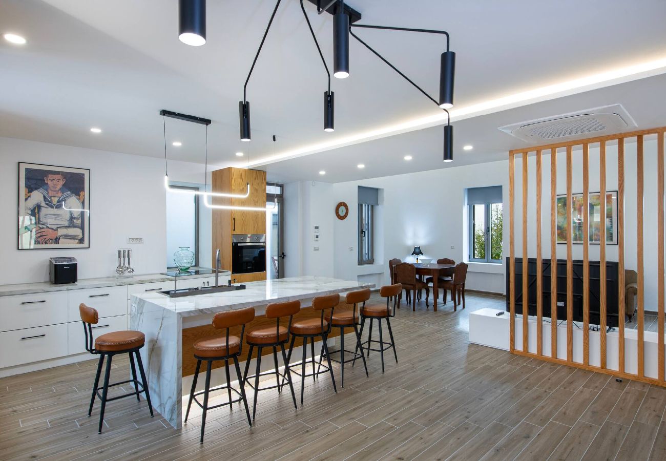 Open-plan kitchen and living room in luxury villa Chania